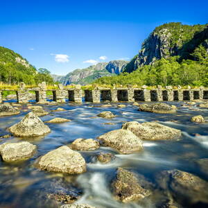 mountains-bridge-river-stones-wallpaper-30292e937b912dca8090679ef854eb0d.jpg