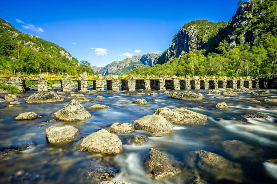 mountains-bridge-river-stones-wallpaper-30292e937b912dca8090679ef854eb0d.jpg