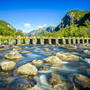 mountains-bridge-river-stones-wallpaper-30292e937b912dca8090679ef854eb0d.jpg